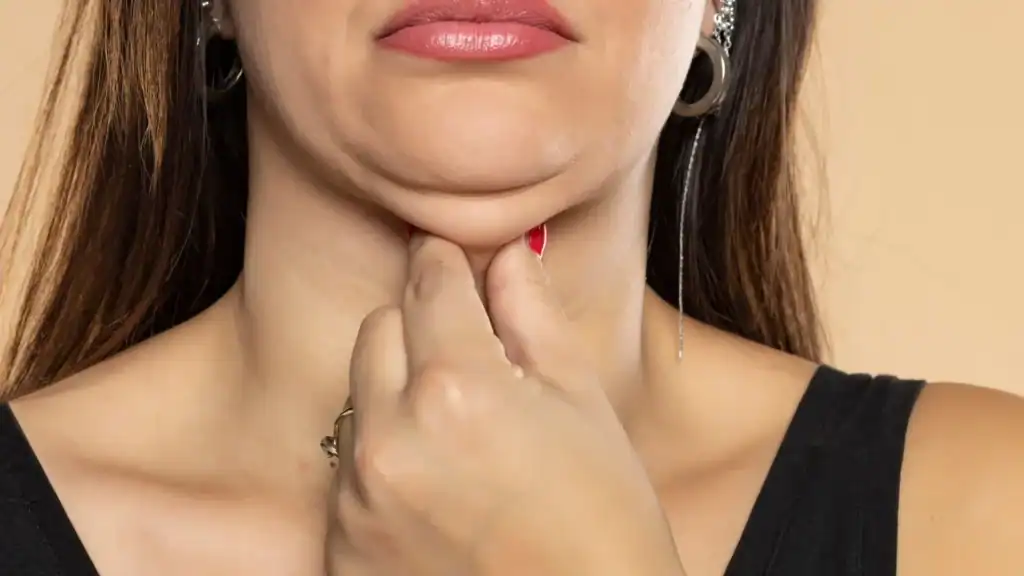 An image of a woman with double chin, sad, worried : Non Surgical Double Chin Removal Treatment in Portobello, UK