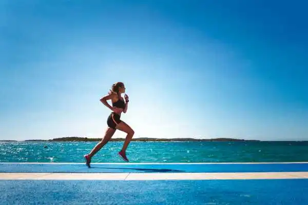 Woman running showing strong leg muscle Portobello